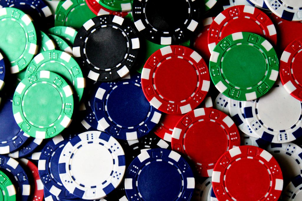 close up of red, green, blue, black and white poker chips