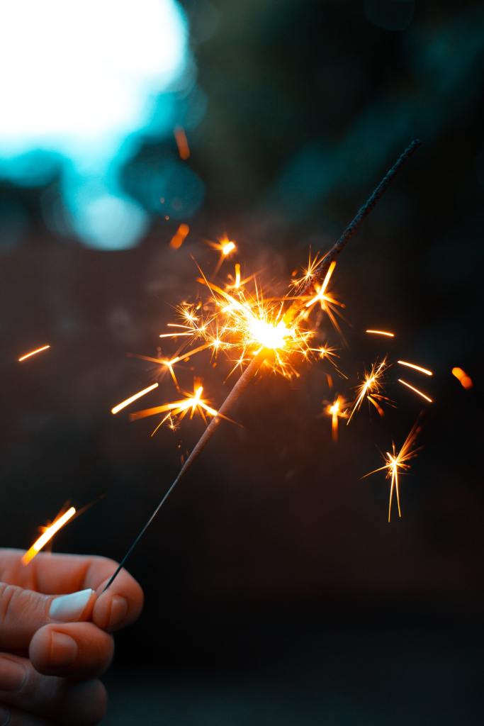 Descriptive image of sparkler burned halfway down. 