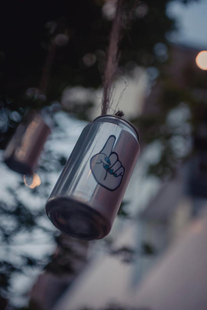 Descriptive image of cans hanging from string. 