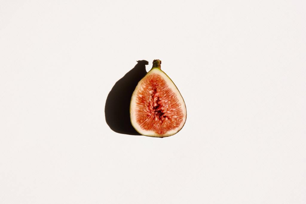 Fig and shadow against a white wall.
