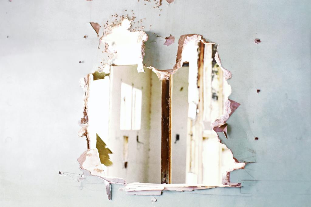 Descriptive image of a hole torn in drywall. 