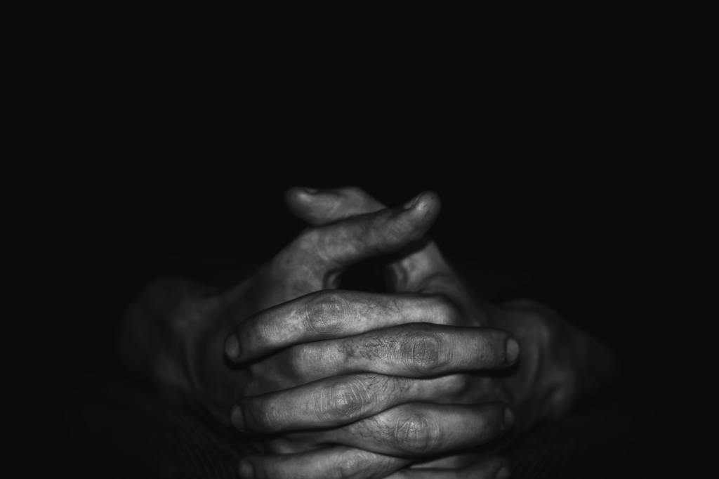Folded hands in black and white