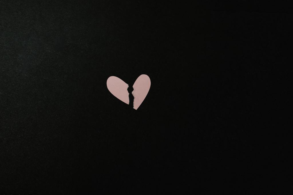 A paper heart ripped down the center, resembling a broken heart. 